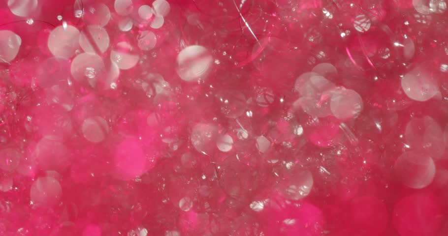 Beautiful sparkling bokeh and soap suds creating a colorful background with changing colors. Rainbow glitter, shimmer, and blur effects creating a magical and relaxing atmospheric motion