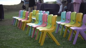 colorful, stackable plastic chairs are commonly referred to as children's learning chairs at the birthady ornament party school and daycares - Powered by Shutterstock - Get 15% off with code: PIKWIZARD15