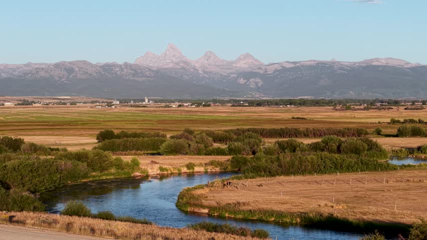 Aerial pan along Snake River of Grand Teton Mountain landscape, Wyoming