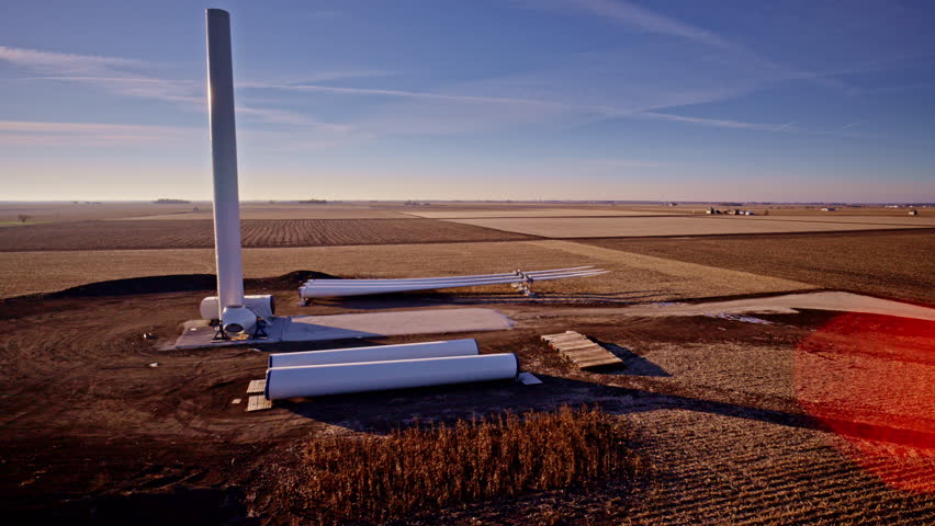 Aerial view of windmill construction across open fields in rural Illinois
