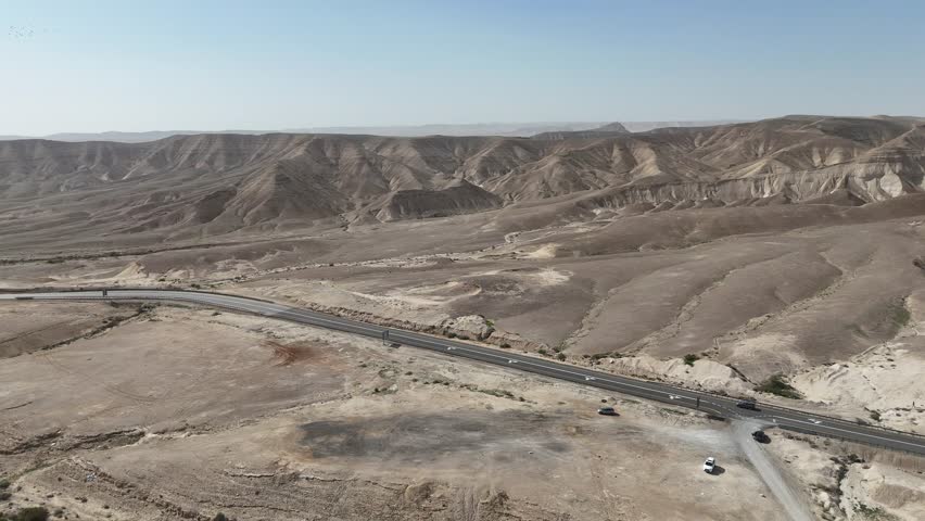 Aerial View of a Lonely Highway Winding Through the Desert Landscape, Israel