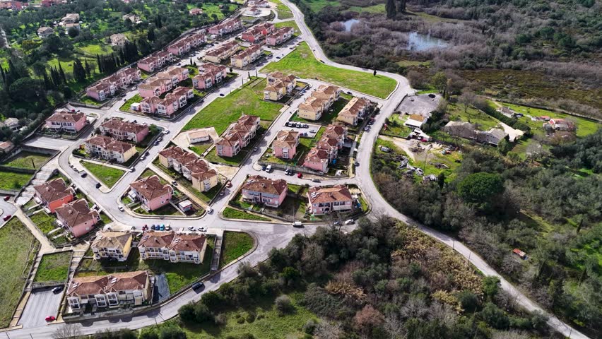 Aerial View of Organized Workers Housing Complex with Residential Blocks and Streets in Green Landscape of Corfu Island Greece