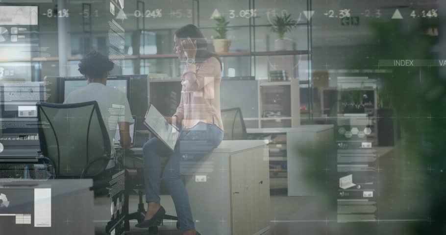 Mid adult woman pointing printed document and guiding review by seated colleague in business office. Collaboration, teamwork, communication, professional, modern, workspace, discussion