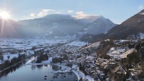 Walensee Switzerland drone flying over Walenstadt town, snowy Swiss alps and calm alpine lake under morning sun. - Powered by Shutterstock - Get 15% off with code: PIKWIZARD15