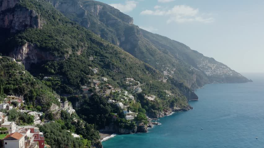 Aerial Drone View Overlooking Amalfi Coastline From a Distance. Narrow Roads Through Rocky Mountains in Italian Landscape.