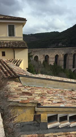 The Ponte delle Torri in Spoleto is a stunning 230-meter-long medieval aqueduct with ten arches, soaring 80 meters over a deep gorge