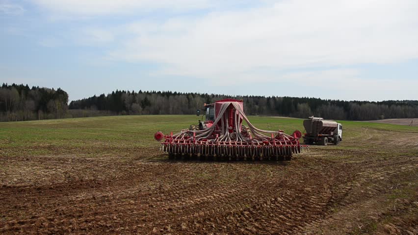 Tractor sowing cereals. Agricultural machinery for planting cereals