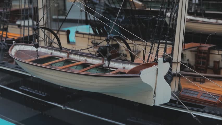 A detailed model of an old boat on display in a museum.