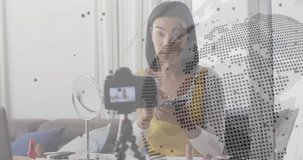 Female creator glancing phone then applying eyeshadow in makeup tutorial with digital overlay. Beauty, cosmetics, glam, influencer, digital, tutorial, vibrant - Powered by Shutterstock - Get 15% off with code: PIKWIZARD15