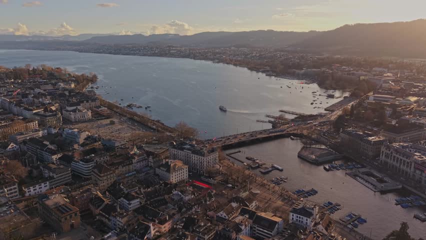 Sunset over Zurich: aerial view of historic architecture, Lake Zurich, and mountains. Zurich, Switzerland. Aerial perspective of Zurich Old Town.