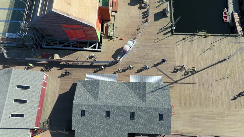 Top View Cyclists glide along the ocean boardwalk, exploring the maritime charm of Halifax. Aerial footage reveals the blend of city, sea, and summer in Nova Scotia.