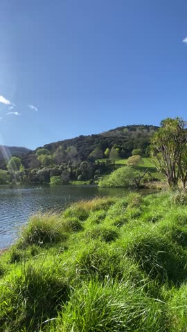 ight Sunny Day at Scenic Lake with Blue Sky and Green Hills
