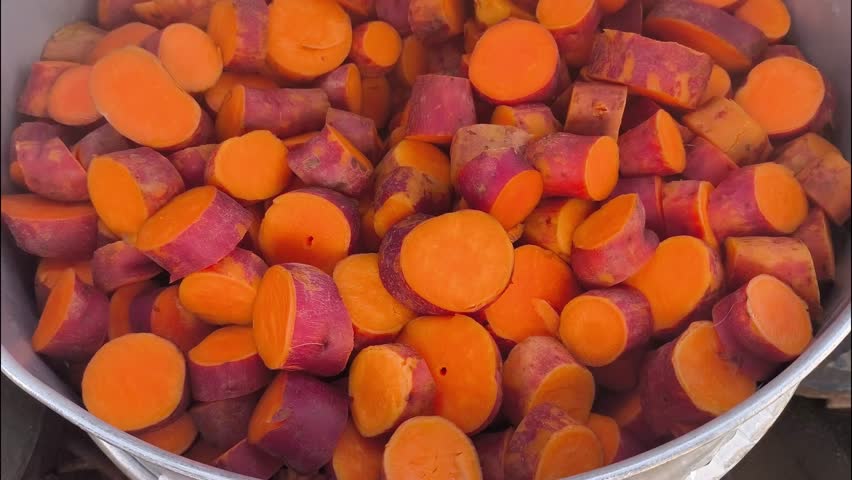 Steaming sweet potatoes in pot, Thai street food.