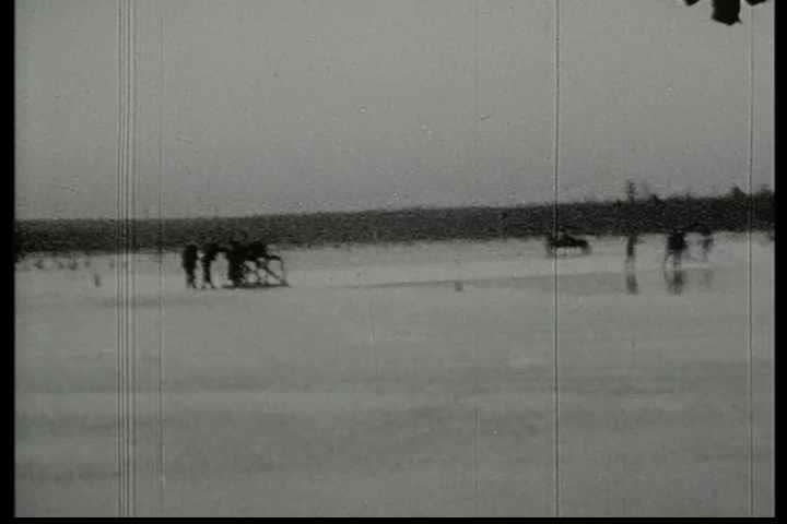1920s - Blocks of ice are cut on an ice field and moved in 1920.