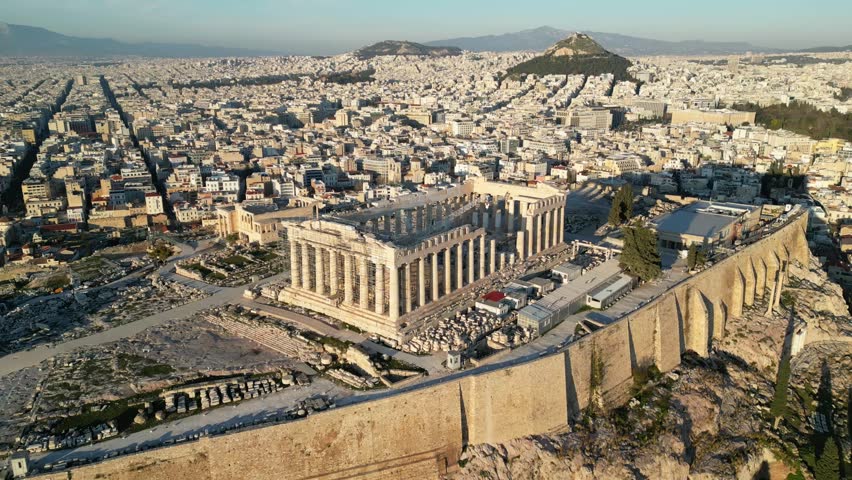 Breathtaking aerial shot of the Acropolis, highlighting ancient architecture amidst the sprawling city of Athens, showcasing historical significance and urban life.