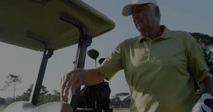 Senior man extending arm toward golf cart, activating finance overlay, gripping wheel for driving. Elderly, leisure, outdoor, technology, financial, innovation, recreation - Powered by Shutterstock - Get 15% off with code: PIKWIZARD15
