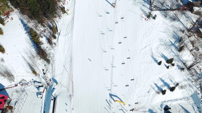 Top Down Aerial View of Ski Lift on Sunny Winter Day