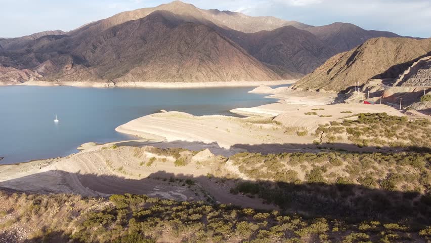 Aerial view of Potrerillos reservoir with mountains in Mendoza, Argentina. Calm, serene, beautiful nature scenery. Use for travel
