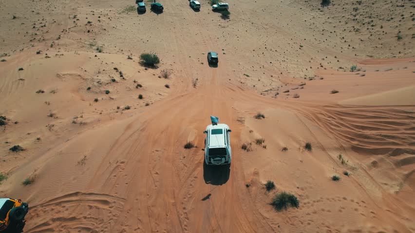 Off-roaders drive their 4WD vehicles through the deep desert during a desert drive in the UAE
