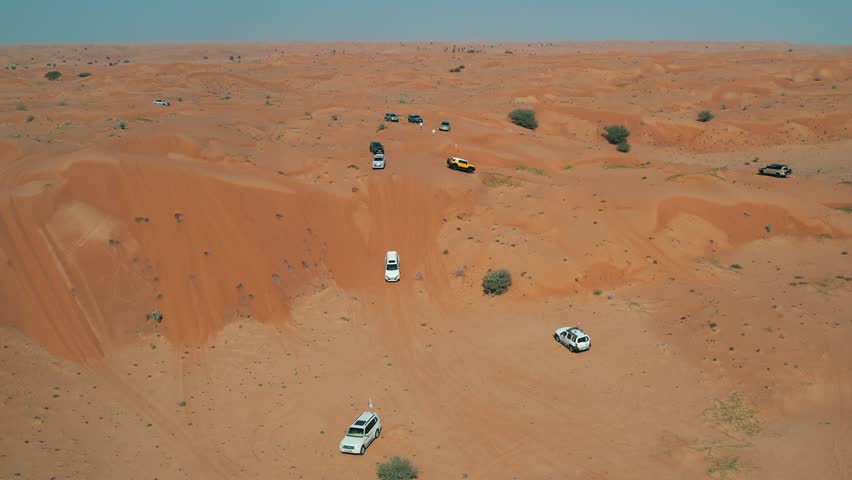 Off-roaders drive their 4WD vehicles through the deep desert during a desert drive in the UAE