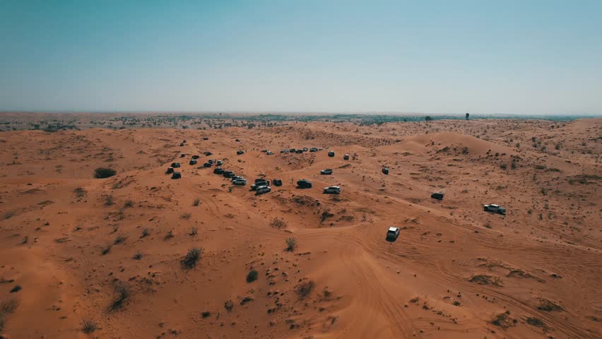 Off-roaders drive their 4WD vehicles through the deep desert during a desert drive in the UAE