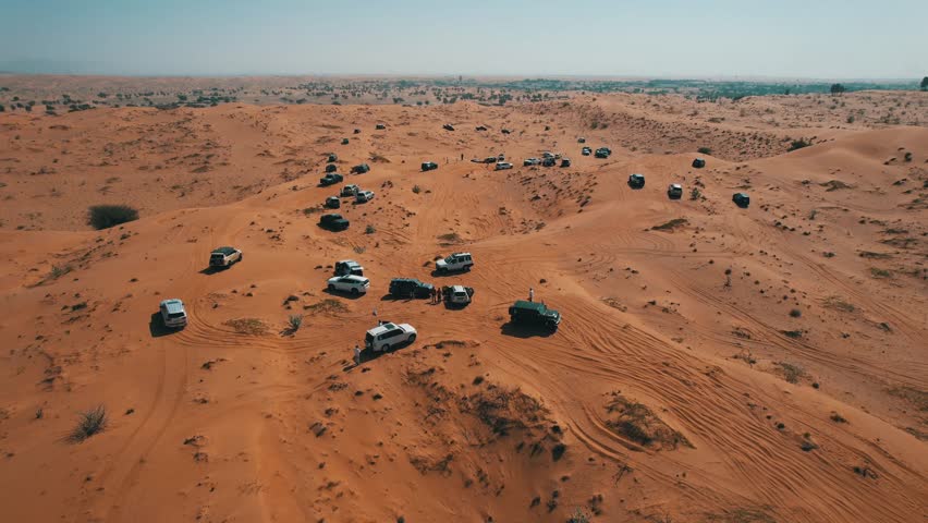 Off-roaders drive their 4WD vehicles through the deep desert during a desert drive in the UAE