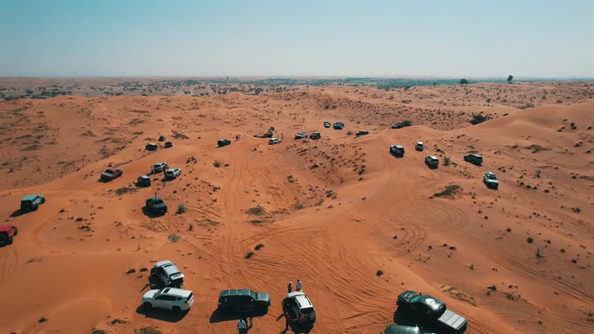 Off-roaders drive their 4WD vehicles through the deep desert during a desert drive in the UAE
