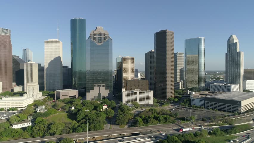 Aerial view of Houston, Texas, showcasing its skyline, skyscrapers, highways, and urban landscape from above.