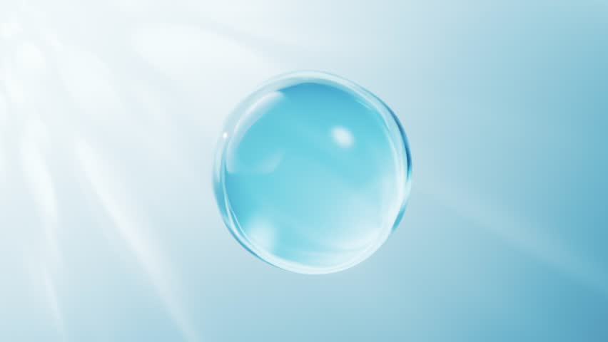 Dynamic close up of clear liquid bubble forming and separating in gentle light motion
