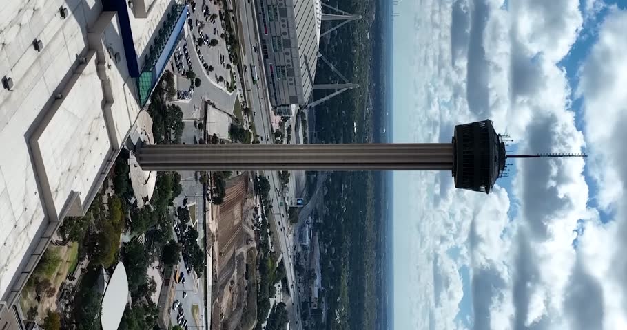 Vertical drone view of San Antonio Tower of the Americas on a cloudy day