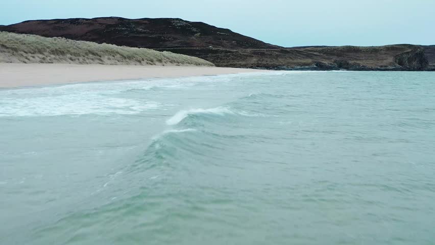Low flying drone shot capturing the incoming tide on Traigh Mhor beach.
