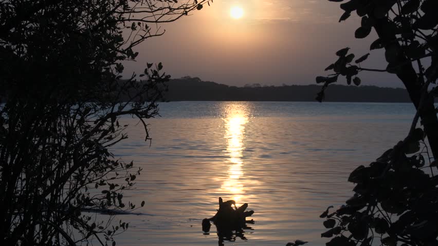 Serene Sunset Over Calm River Waters