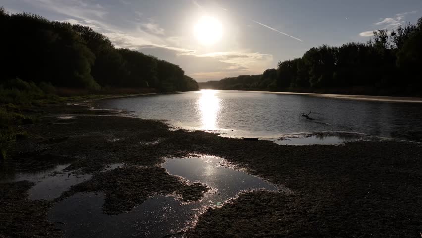 Serene Sunset Over a Calm River with Trees