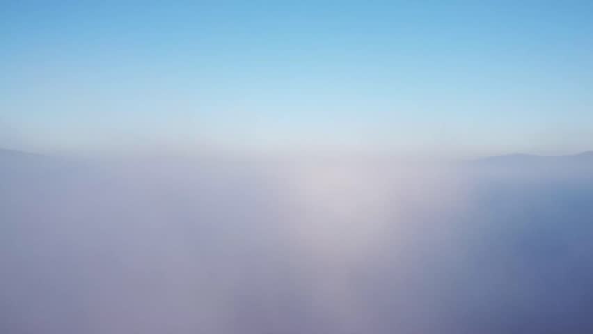 Aerial View of Mountains Above the Clouds.