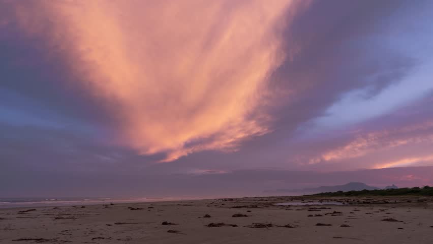 Stunning Beach Sunset with Vibrant Clouds.