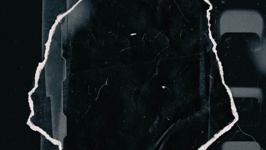 The background has a black and white theme, resembling torn paper, creating the effect of looking through a hole while snow and dust swirl around.