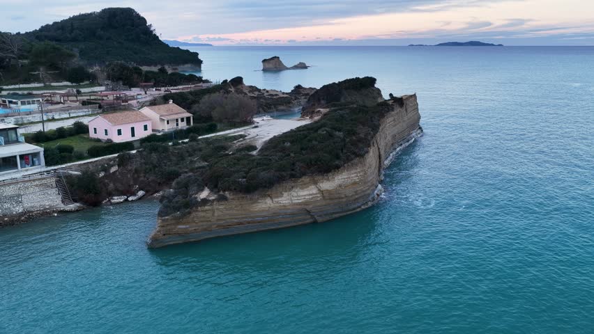 Cinematic aerial drone landscape of Canal d'Amour coastline at sunset with calm sea and distant islands, Sidari, Corfu, Greece, scenic romantic travel background