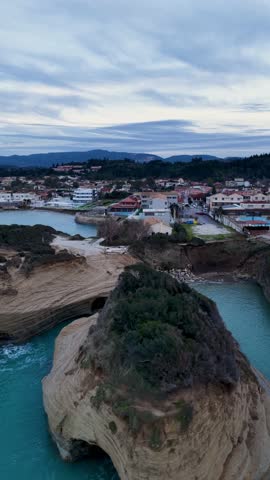 Aerial view of Sidari coastal resort town and hotels near the famous Canal d'Amour cliffs during evening, Corfu Island, Greece, summer holiday destination