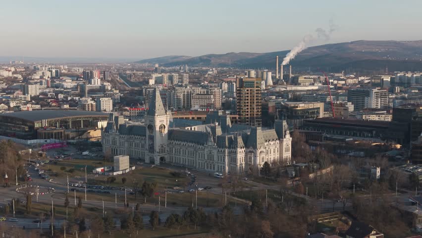 Aerial drone view of Palace of Culture in Iași with surrounding buildings, streets and winter skyline under clear cold light