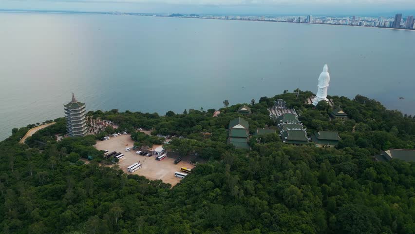 religious Lady Buddha monument at Linh Ung pagoda and buddhism temple, Asian religion and spirituality, Son Tra peninsula, Da Nang, Vietnam 4k aerial drone view
