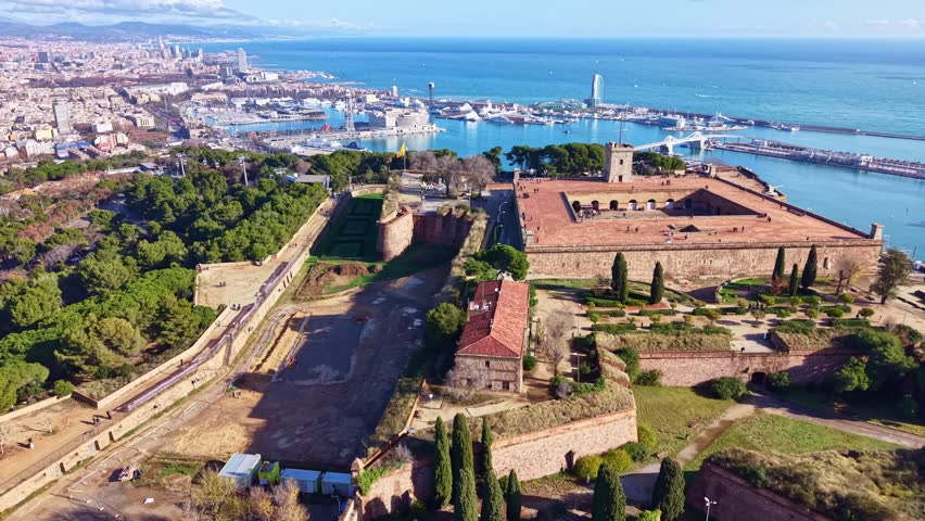 Distant drone overview of the Montjuic Castle medieval military fortress and the Montjuic hill environment, Barcelona, Catalonia, Spain