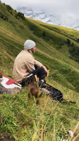 Woman Walking Toward Picnic with Man and Dog.

Woman approaching a picnic spot where a man and dog wait in the mountains.