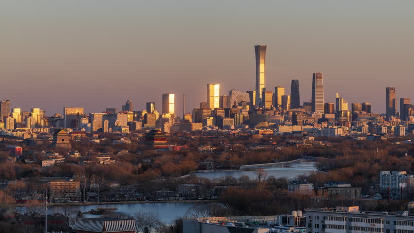 Day to night time-lapse of Beijing Ancient Bell and Drum Towers, and Shichahai against the distant CBD skyline and CITIC Tower