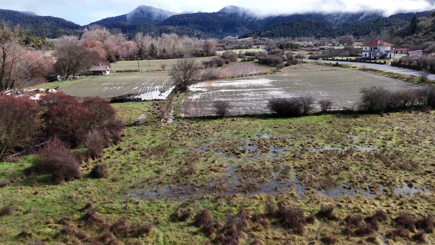 Aerial Landscape with Mountains, Clouds, and Fields