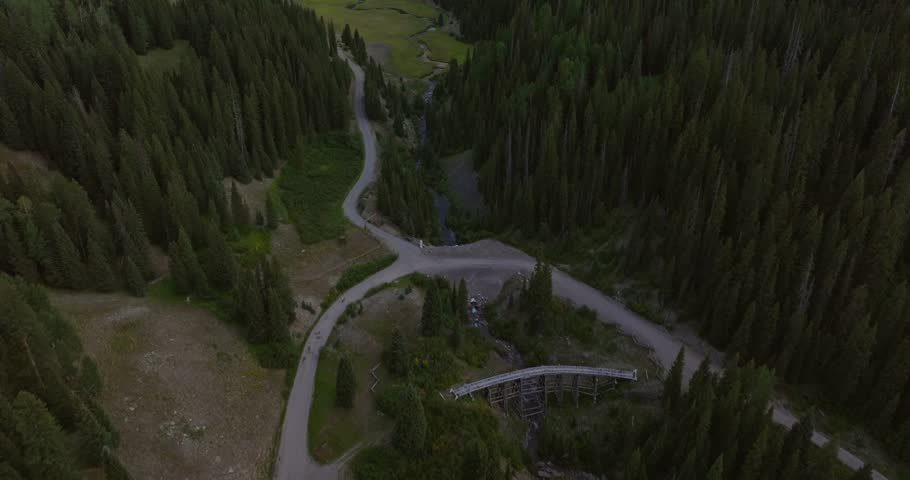 Beattie Peak towers above the Rio Grande Southern Trestle Bridge, establishing aerial tilt up