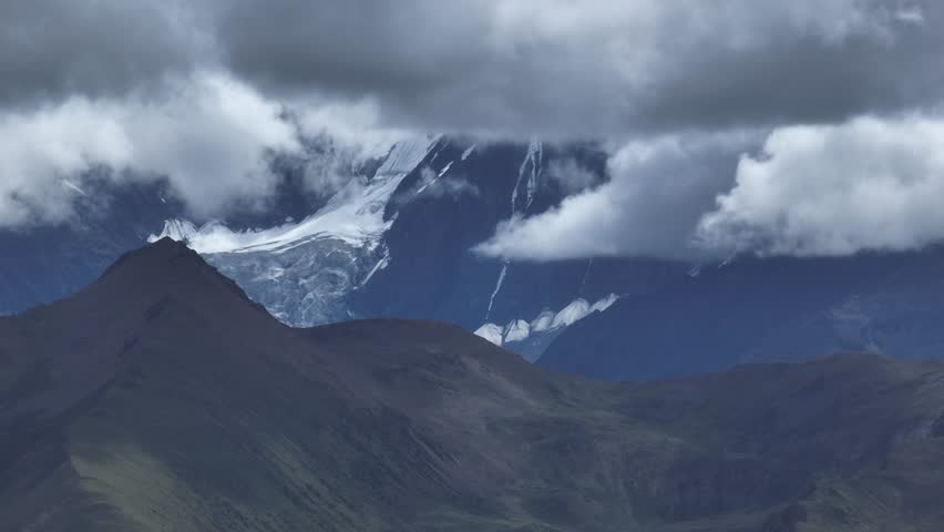Aerial footage landscape of foggy snow capped mountains in sichuan, China