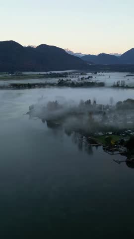 Aerial View of a Misty Lakeside Town at Sunrise in British Columbia, Canada