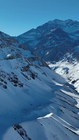 Aconcagua, a mountain in the Andes Mountains between Chile and Argentina. Aerial view in vertical video.