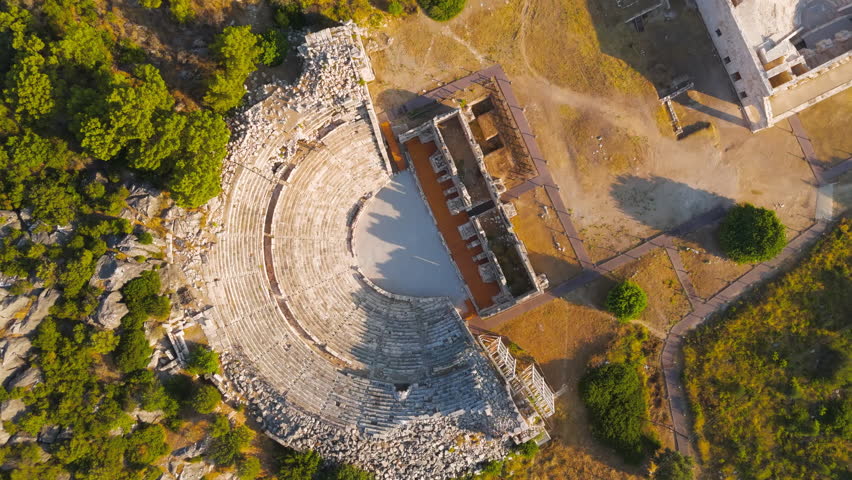 Gelemis, Turkey. Ancient Theatre complex at Patara with Kursunlu Hill, historical architecture and archaeological site in morning. Aerial View, MasterShots, Tilt up, Tilt down