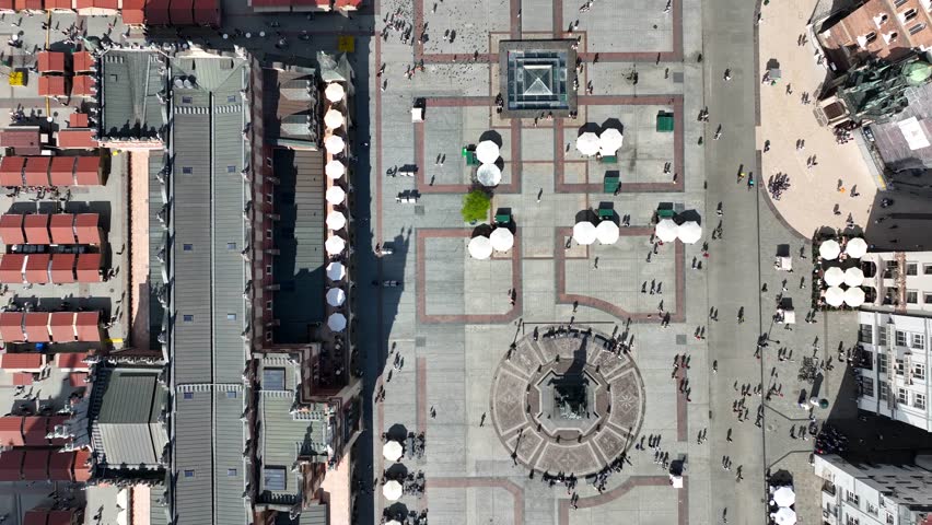Low altitude aerial flyover of Rynek Główny Square with St. Mary’s Basilica and historic Old Town architecture, Kraków, Poland